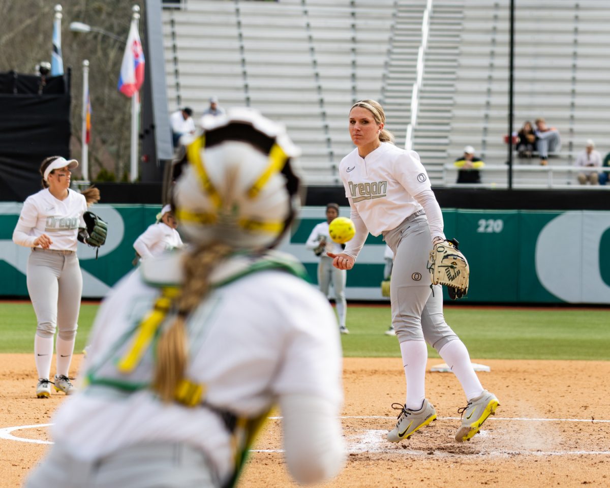 Oregon catcher Emma Cox (21) receives a warmup pitch from pitcher Lyndsey Grein (33) between innings. Oregon Ducks softball takes on the Nevada Wolf Pack at Jane Sanders Stadium in Eugene, Ore., on March 8, 2026, winning 7-3. (Owen Burriss/Emerald)
