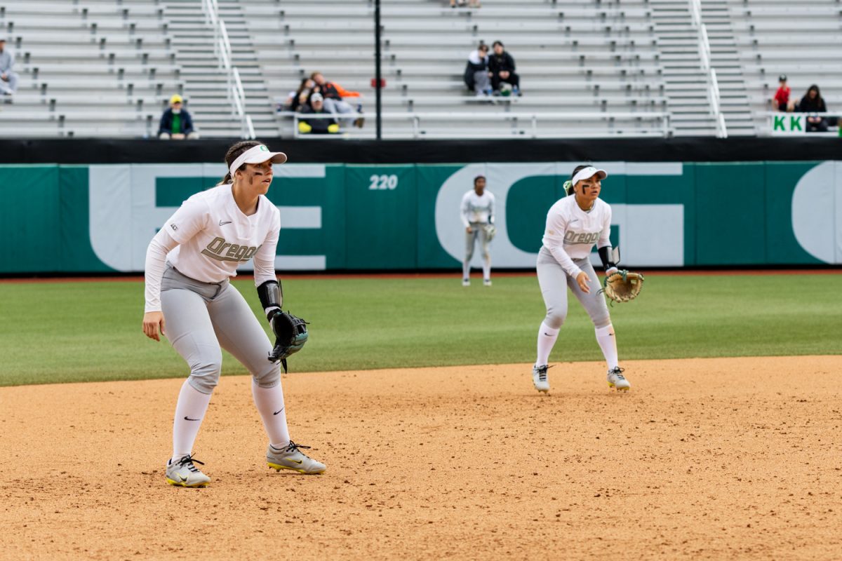 Oregon infielders Katie Flannery (left) and Taryn Ho (right) get into defensive positions. Oregon Ducks softball takes on the Nevada Wolf Pack at Jane Sanders Stadium in Eugene, Ore., on March 8, 2026, winning 7-3. (Owen Burriss/Emerald)