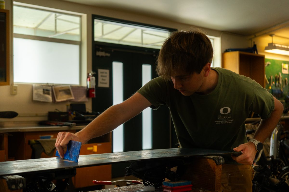 Ben, University of Oregon student scrapes the old wax off of his snowboard before applying a new coat. The "Outdoor Program Barn" at the University of Oregon, sitting on the corner of 18th and University St in Eugene, Ore., provides equipment and makes outdoor activities more accessible for students. (Katie Poluyansky/Emerald)