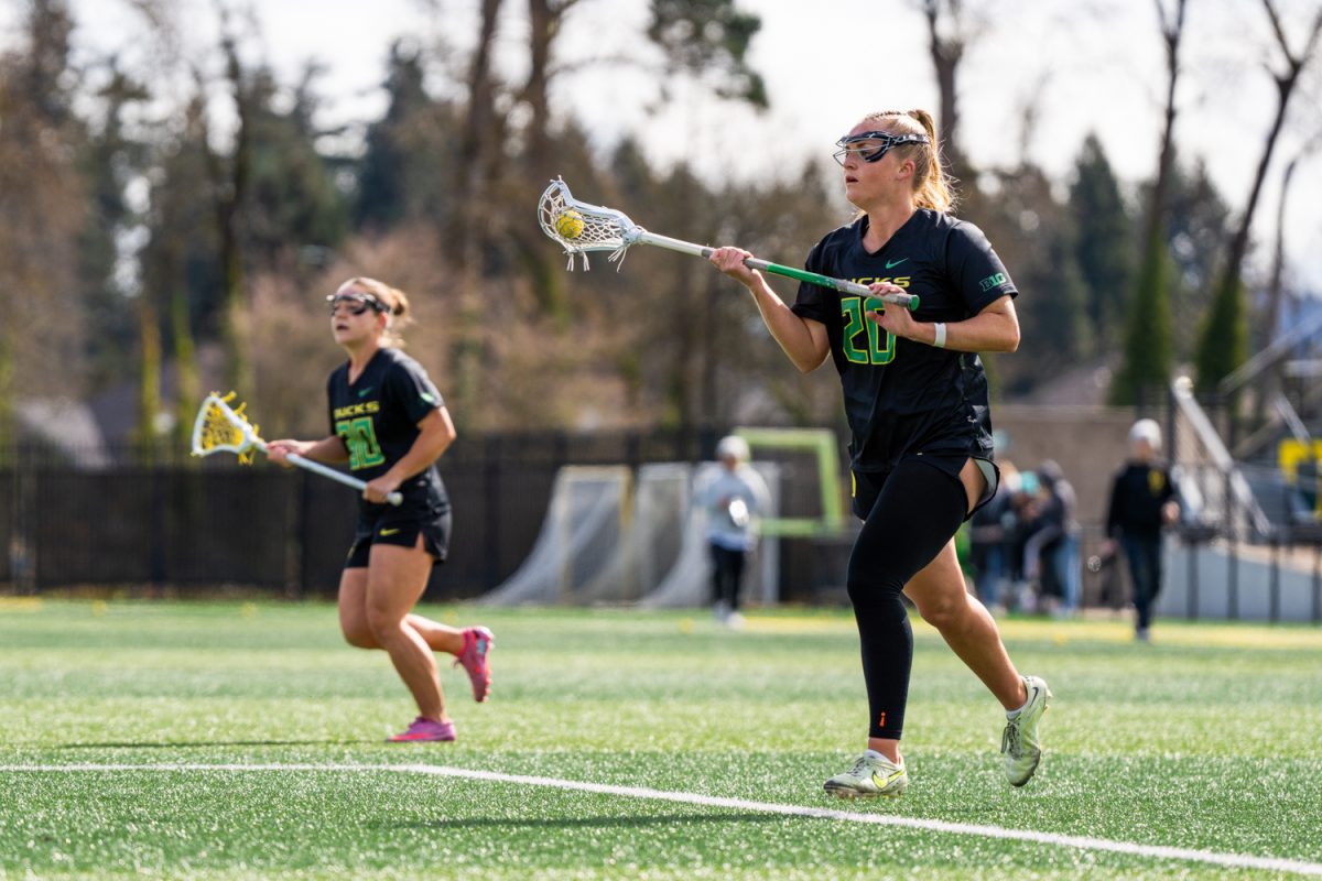 Oregon attacker Emma Ing (20) carries the ball to center feild. University of Oregon Ducks Women’s Lacrosse team host the #3 ranked University of Maryland Terps in a home match, losing 15-7 at Papé Field in Eugene, Ore., on Mar. 14, 2026. (Rowan Campbell/Emerald).