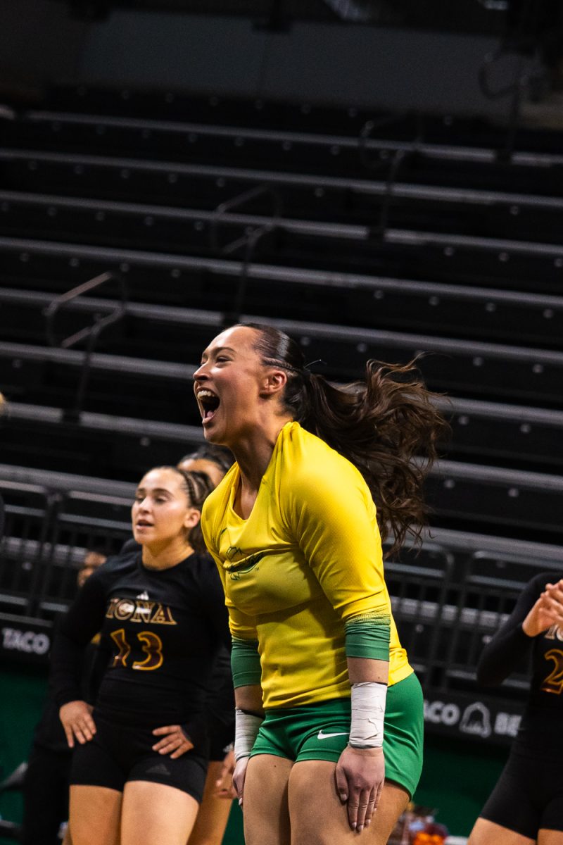 Duck junior tumbler Sophia Wing (2) celebrates after a successful tumble. On March 15, 2026 the University of Oregon Ducks Women’s Acrobatics and Tumbling team beat the Gaels in a tight home meet against Iona University at Matthew Knight Arena in Eugene, Ore. (Katie Poluyansky/Emerald).