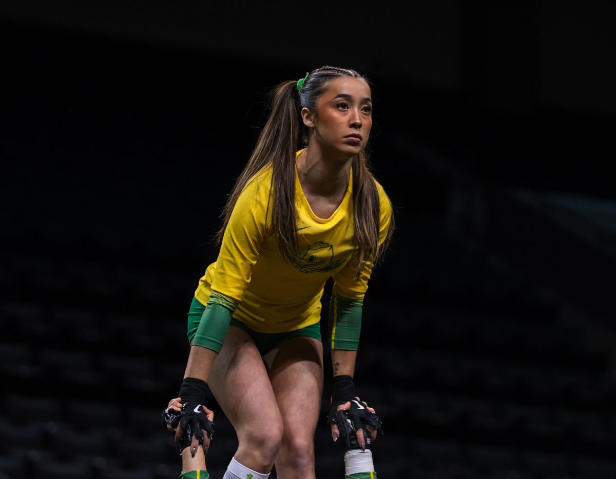 Duck top sophomore Maya Khauv (40) focuses to stay balanced. On March 15, 2026 the University of Oregon Ducks Women’s Acrobatics and Tumbling team beat the Gaels in a tight home meet against Iona University at Matthew Knight Arena in Eugene, Ore. (Katie Poluyansky/Emerald).