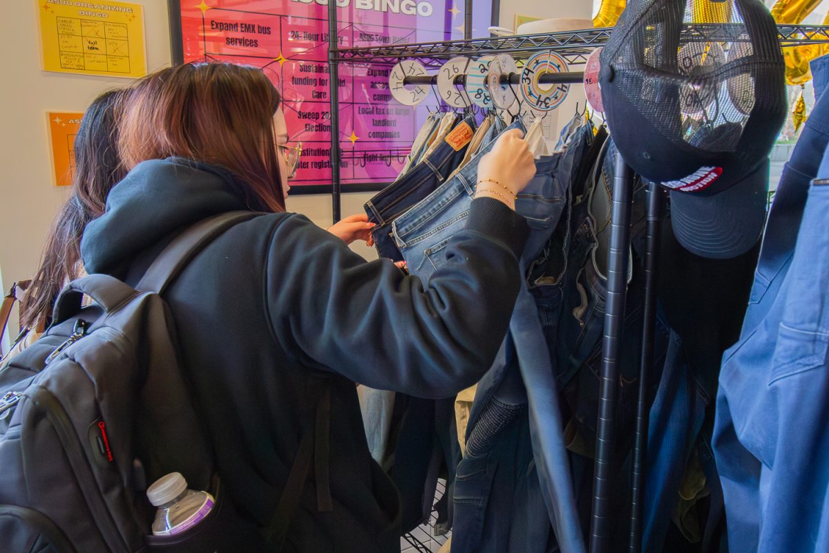 Students shop around the different racks of clothes. On Feb. 26, 2026, The ASUO and Rose Room collaborated to host a clothing pop up at the ASUO Office, at University of Oregon, based in Eugene, Ore. (Fred Hall/Emerald)