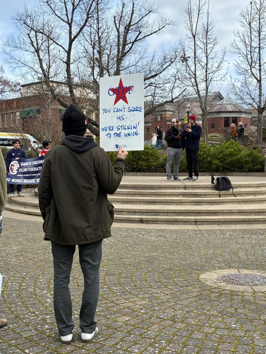 A member of GTFF stands at the rally that preceded the union's first bargaining session on Monday, March 9 (Sasha Love/Emerald).