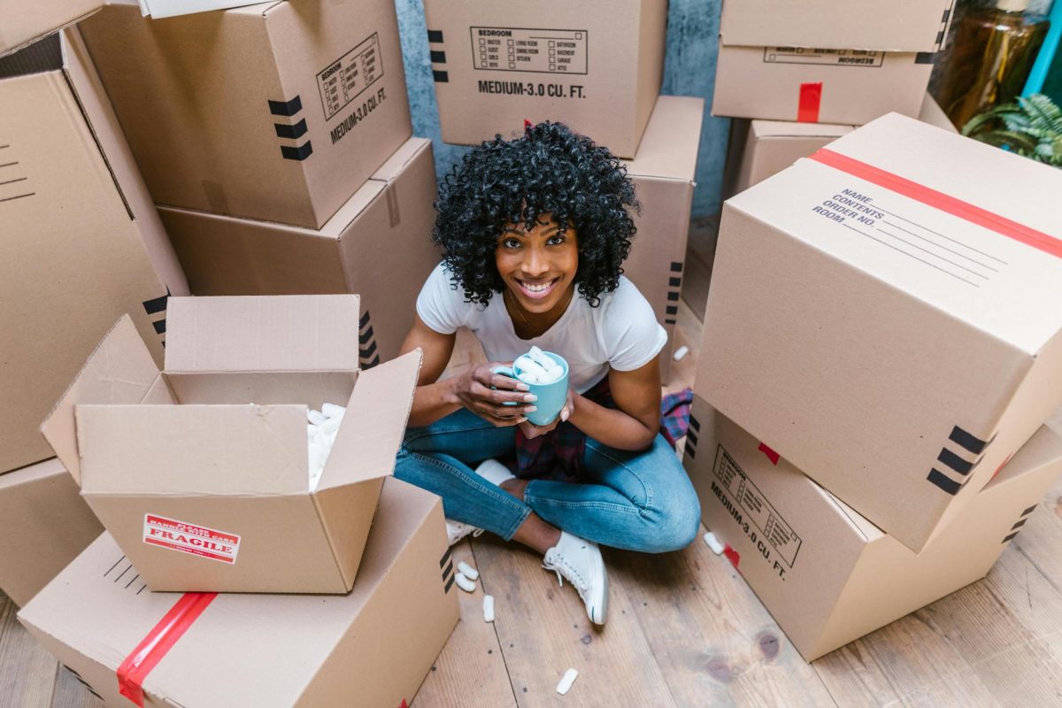 https://www.pexels.com/photo/girl-in-blue-shirt-sitting-on-brown-cardboard-box-7464698/