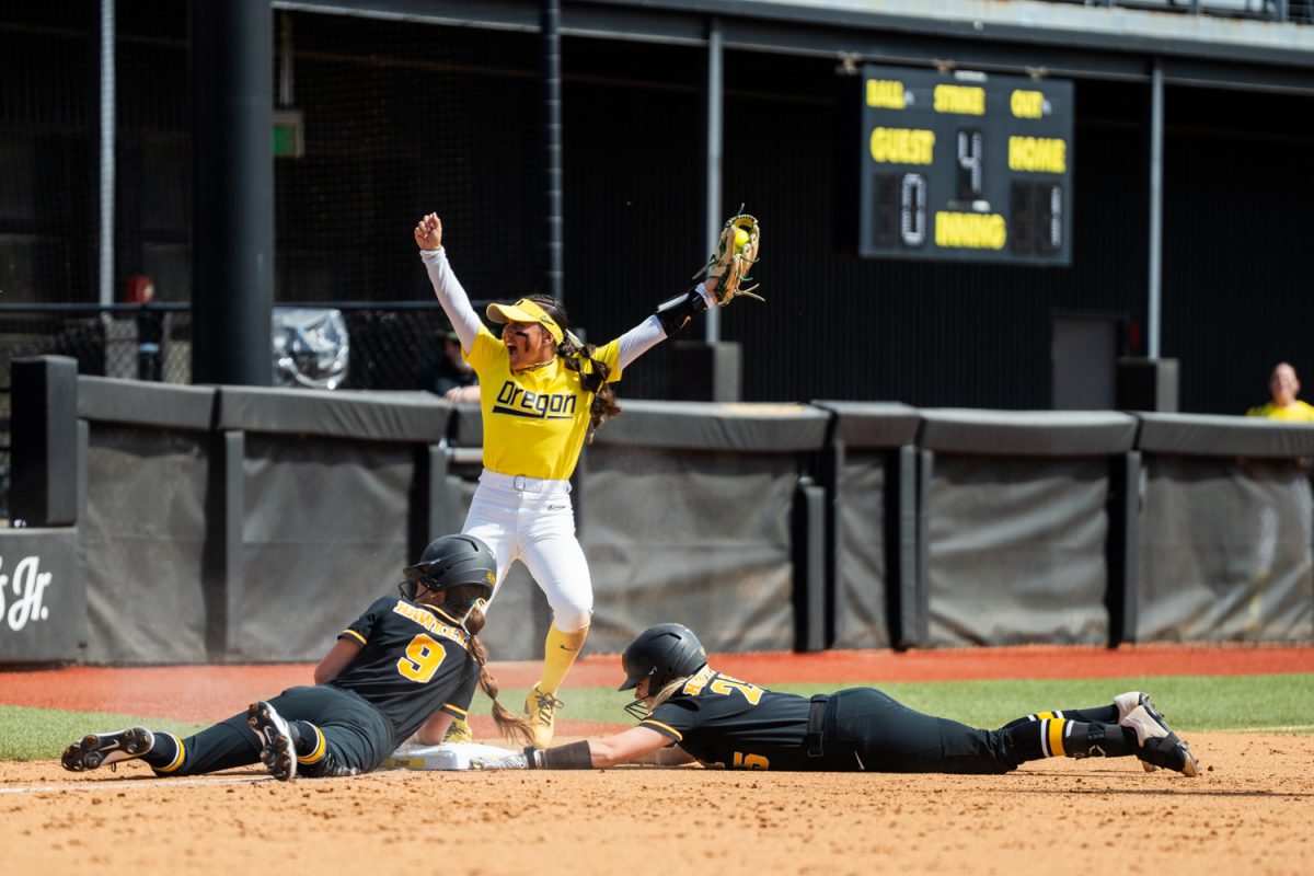 Oregon infeilder 
Taryn Ho (1) tags both Iowa runners out on third base after an at bat bunt. The University of Oregon Ducks Women’s Softball team win in a home game against the Iowa Hawkeyes 6-2 in Eugene, Ore., on Apr. 5, 2026. (Rowan Campbell/Emerald).