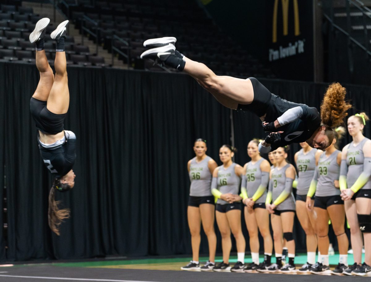Top/Tumbler Briya Alvarado flips through the air during the duo pass of the tumbling event. The University of Oregon Acrobatics and Tumbling team took on Baylor University at Matthew Knight Arena in Eugene, Ore., on April 6, 2026, ultimately losing 278.080 to 272.530. (Saj Sundaram/Emerald)