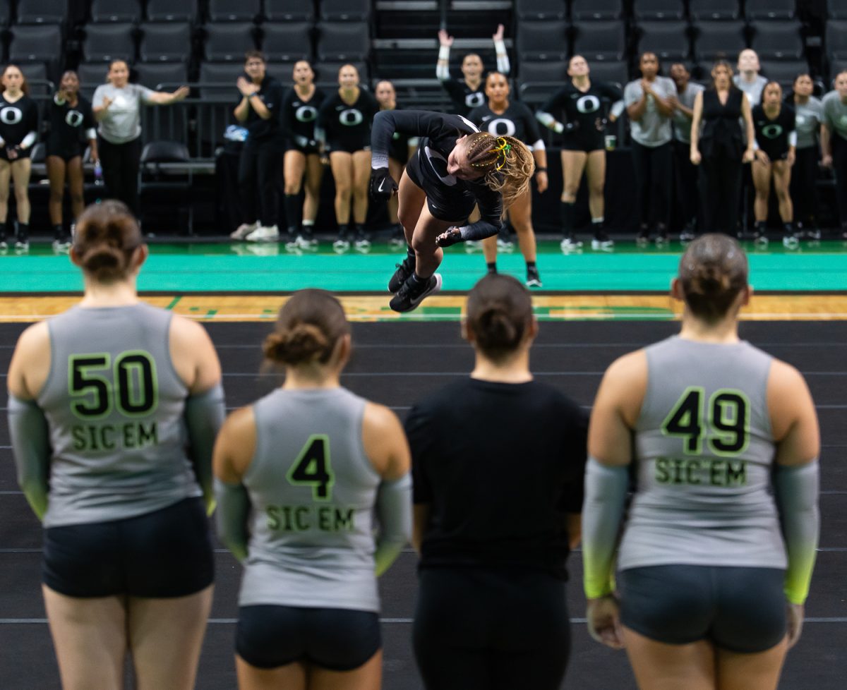 Top/Tumbler Carly Garcia flies through the air during a pass in the tumbling event. The University of Oregon Acrobatics and Tumbling team took on Baylor University at Matthew Knight Arena in Eugene, Ore., on April 6, 2026, ultimately losing 278.080 to 272.530. (Saj Sundaram/Emerald)