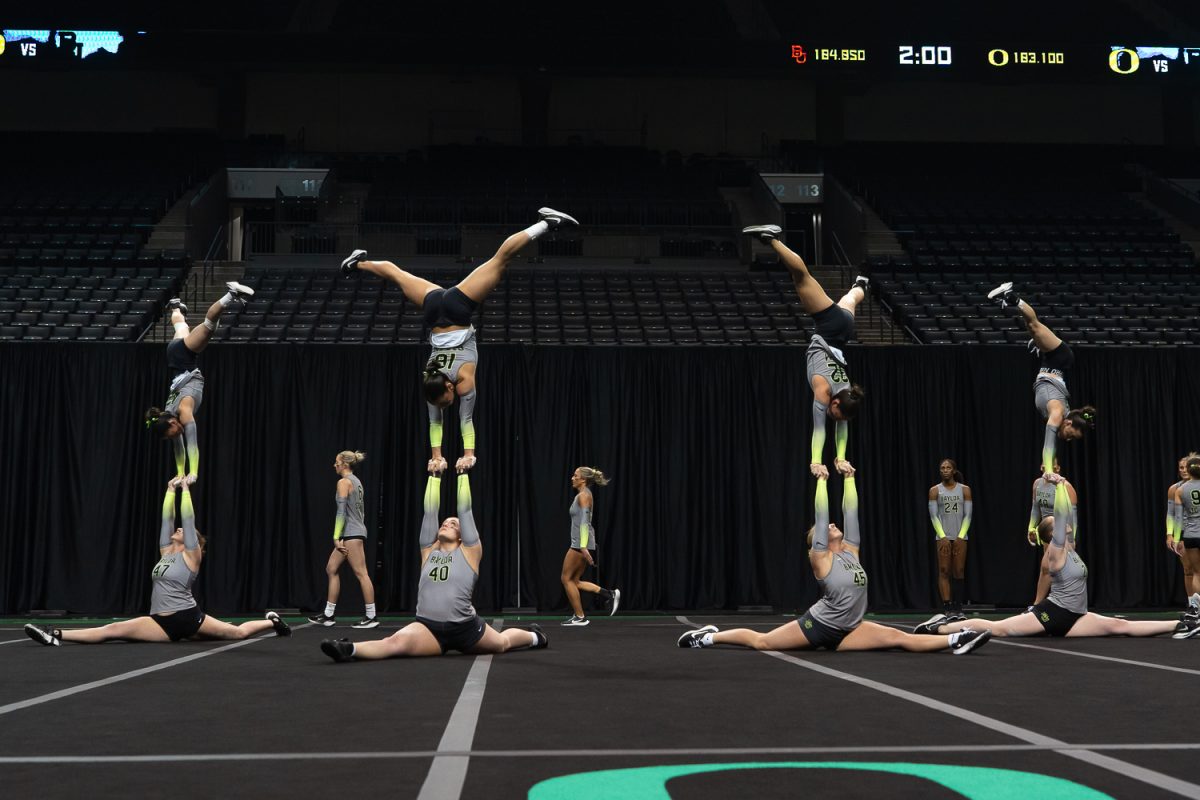 Tops of the Baylor University Acrobatics and Tumbling team are held up by bases who are doing the splits on the ground. The University of Oregon Acrobatics and Tumbling team took on Baylor University at Matthew Knight Arena in Eugene, Ore., on April 6, 2026, ultimately losing 278.080 to 272.530. (Saj Sundaram/Emerald)