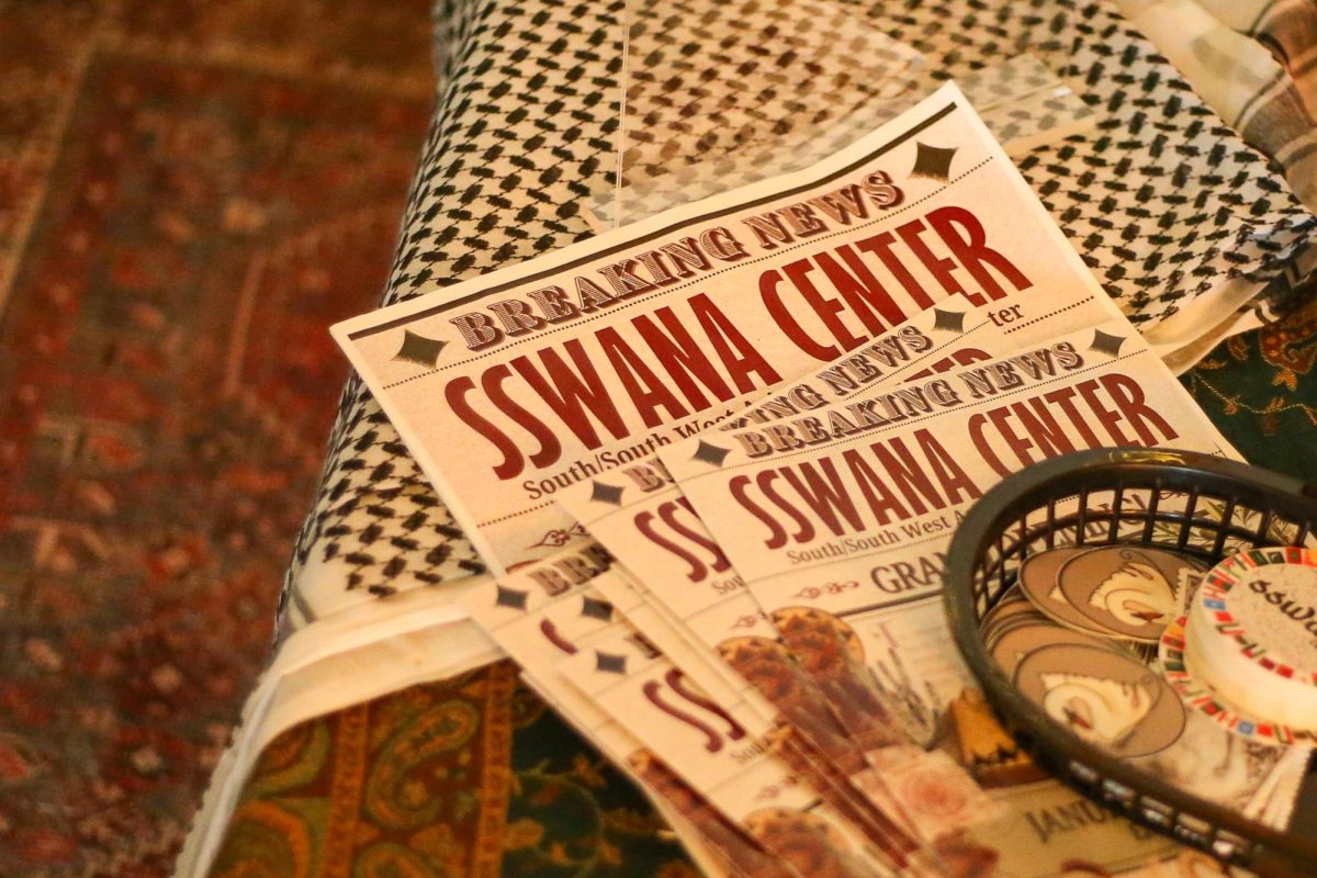 A newspaper from the grand opening of the SSWANA center is displayed. The SSWANA center sits on the second floor of the Erb Memorial Union in Eugene, Ore., on April 7, 2026 (Tyler Graham/Emerald)