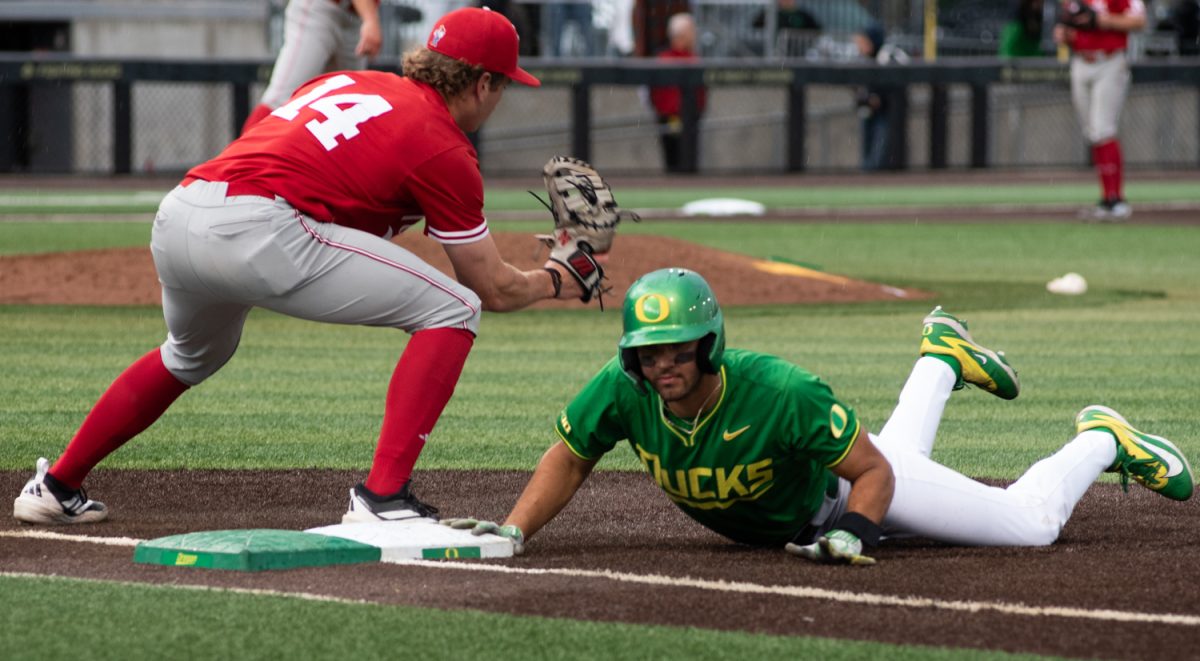 Oregon outfielder Angel Laya (53) dives back to base when the pitcher attempts a pickoff. No. 21 Oregon baseball takes on No. 19 Nebraska on April 10th, 2026, at PK Park, in Eugene, Ore. (Chris Castro/Emerald)