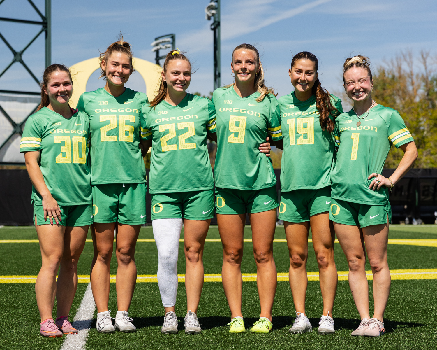 Oregon seniors Anna Simmons (30), Shelby Hahn (26), Jadyn Laing (22), Kylee Manser (9), Jenae Sperling (19), and Rachel Pallo (1) pose together after their final game at Pape Field. The Oregon Ducks women’s lacrosse team hosted USC for their senior game at Pape Field in Eugene, Ore., on April 18, 2026, losing 15–10. (Owen Burriss/Emerald)