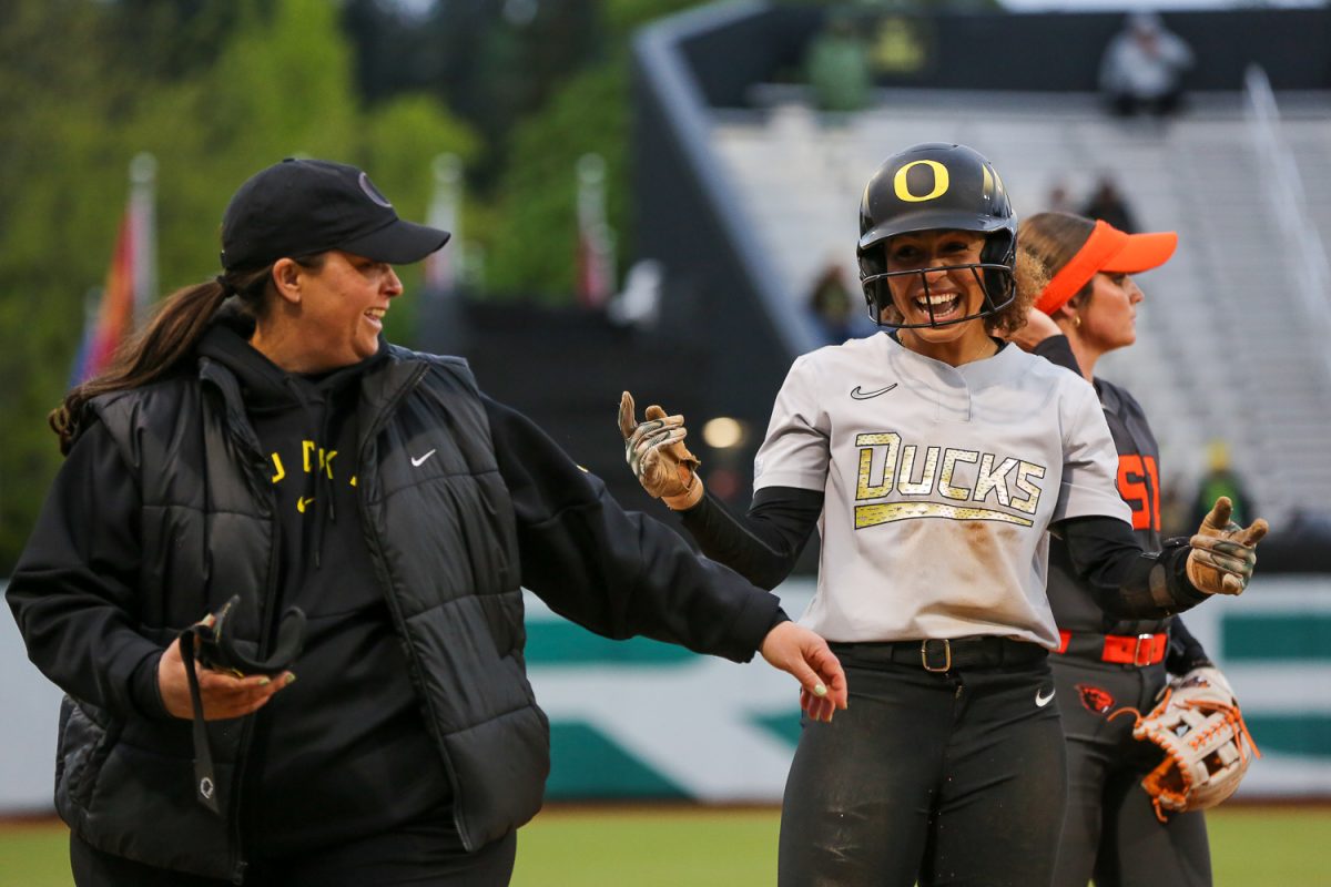 Oregon Duck Amari Harper (31) smiles with her coach. Oregon softball faces off against the Oregon State Beavers at Jane Sanders Stadium in Eugene, Ore. on April 22, 2026. (Heidi Thalman/Emerald)
