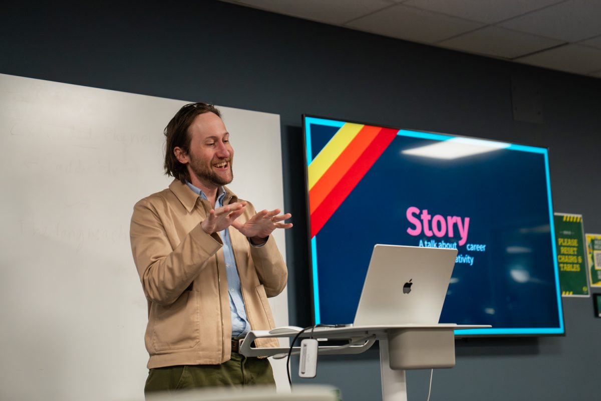 Oregon alum Simon Adler laughs while recalling his time as an Oregon student. Adler spoke on April 23, 2026, at the Knight Library in Eugene, Ore., to offer his perspective to undergraduate students who are interested in media and arts. (Lilly Wall/Emerald)