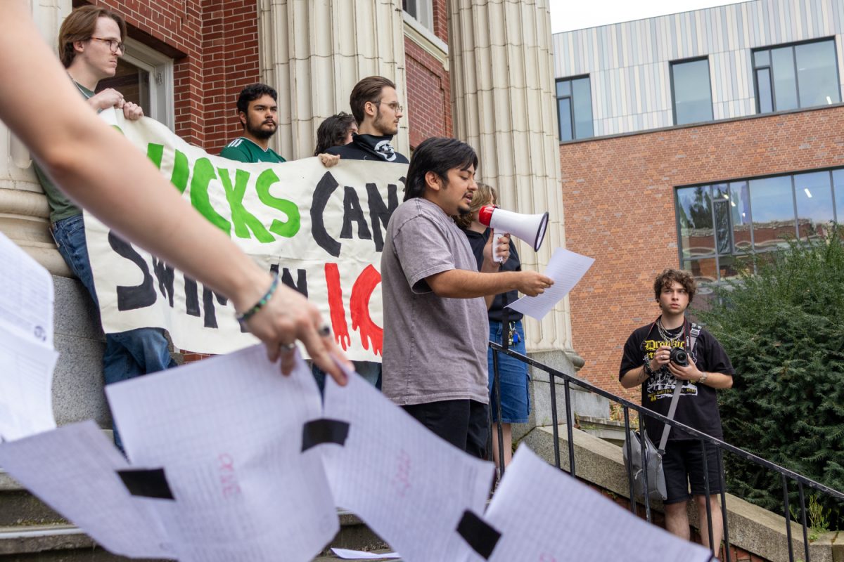 Toby, a representative of UO MEChA and the Young Democratic Socialists of America, spoke on the steps of Johnson Hall before the UO Anti-ICE Coalition delivered a letter demanding protection from ICE to the office of President Karl Scholz. The Coalition’s demands include a UO alert system, a university commitment to not using the code of conduct against those peacefully opposing immigration enforcement, a Latiné Student Coalition and a comprehensive safety plan. (Corey Hoffman/Emerald)