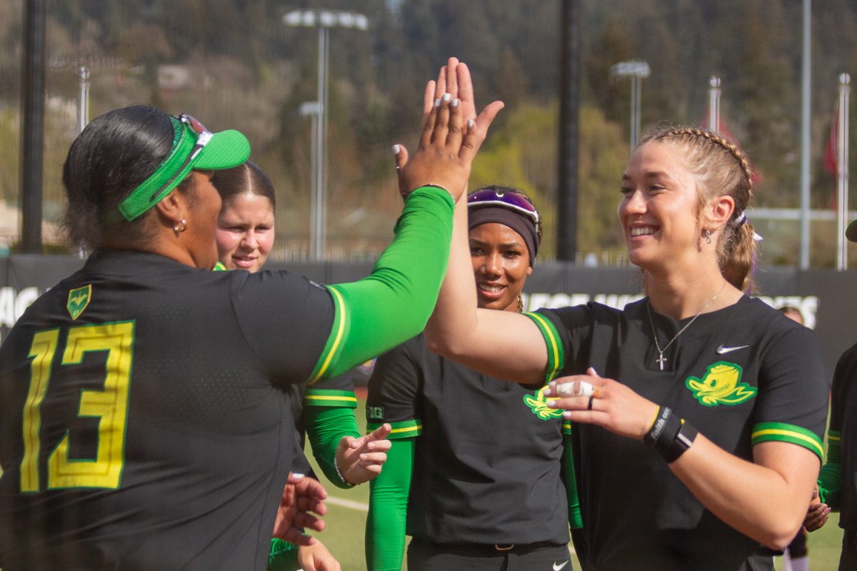Oregon catcher Trinity Holden (67) high-fives Oregon infielder Stefini Ma’ake (13) before the game. On April 4, 2025, the Oregon Ducks played the Iowa Hawkeyes at Jane Sanders Stadium, at University of Oregon, based in Eugene, Ore. (Fred Hall/Emerald)