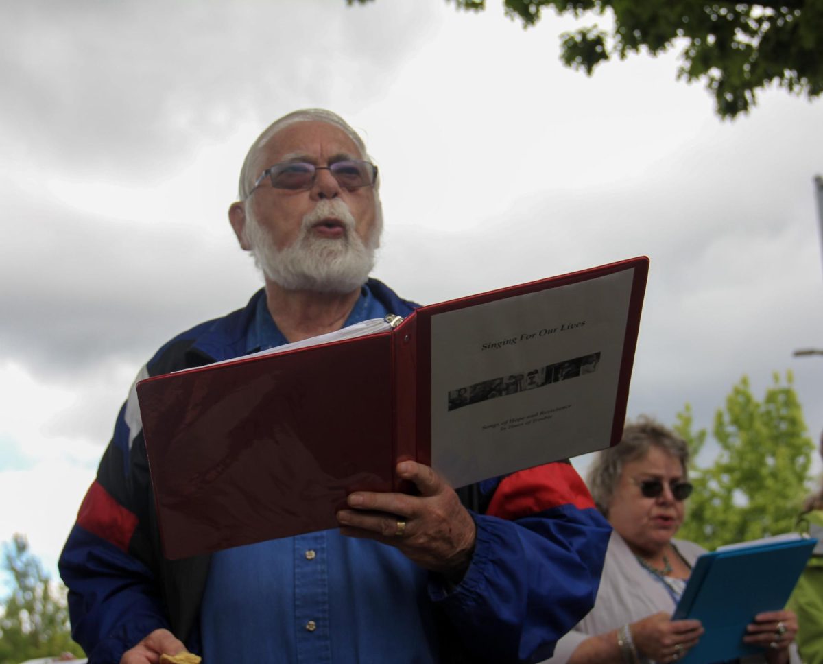 A protester sings during the weekly Singing for Our Lives demonstration outside the Eugene Federal Building on June 4, 2026, in Eugene, Ore. (Tarek Anthony/Emerald)