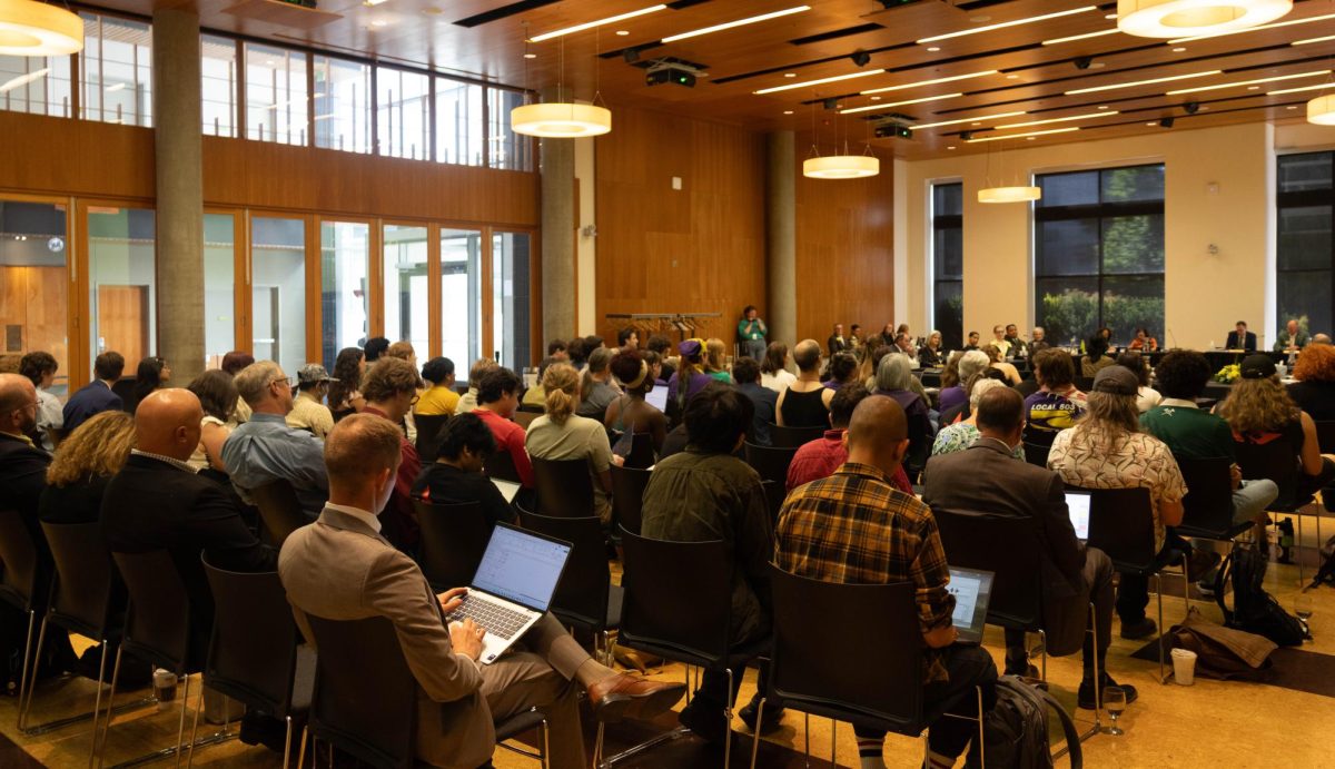 Dozens of students, faculty members, staff and community members fill the room during public comment at a University of Oregon Board of Trustees meeting at the Ford Alumni Center on June 2, 2026, in Eugene, Ore. Public comment topics included budget cuts, climate goals, support for the Latinx Student Cultural Center and the Israel-Hamas war. (Tarek Anthony/Emerald)