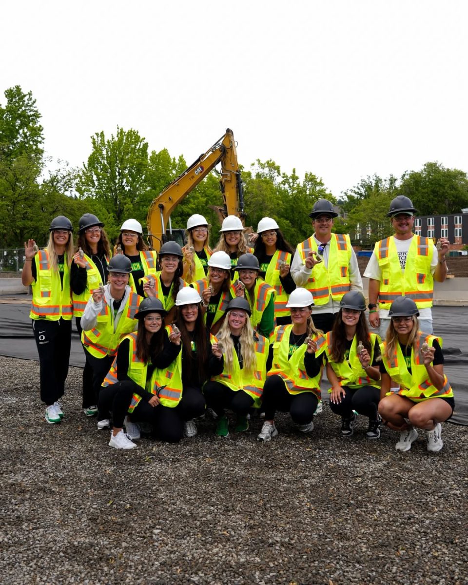 Members of the Oregon women's beach volleyball team gather at the construction site of their future court as the first load of sand is delivered on May 29, 2026, in Eugene, Ore.
